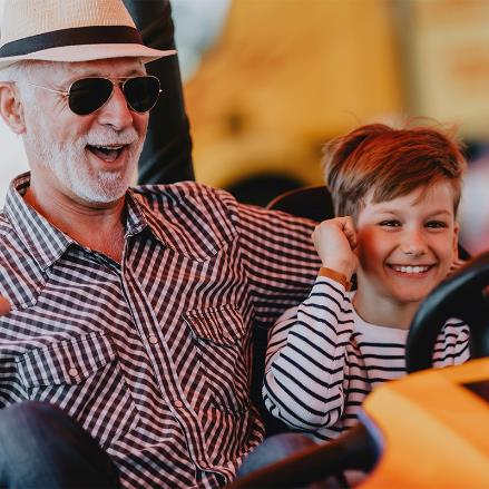 A grandfather and his grandson protect their ears on a noise carnival ride in Tennessee. 